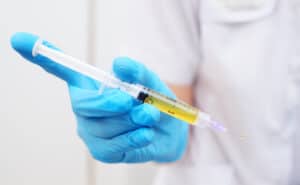 Physician holding a syringe with Platelet Rich Plasma (PRP)